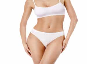 Woman in white bikini, showing a slim, toned physique after SmartLipo